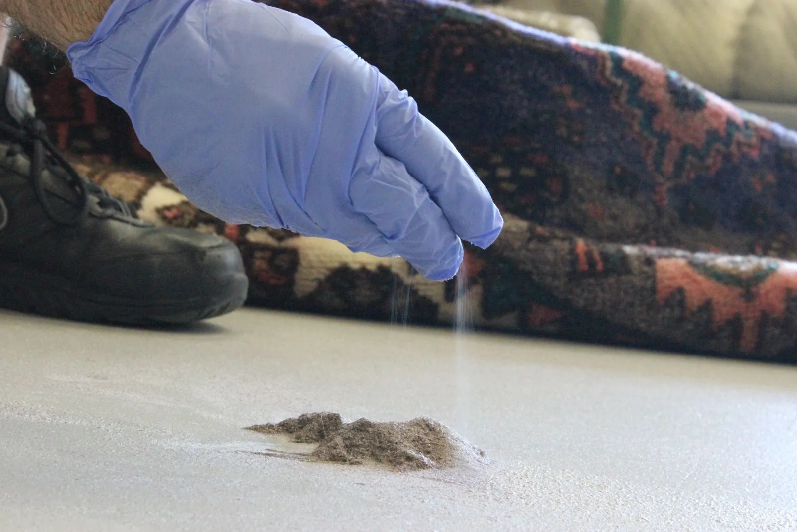 Pile of dry soil extracted from an area rug during dusting