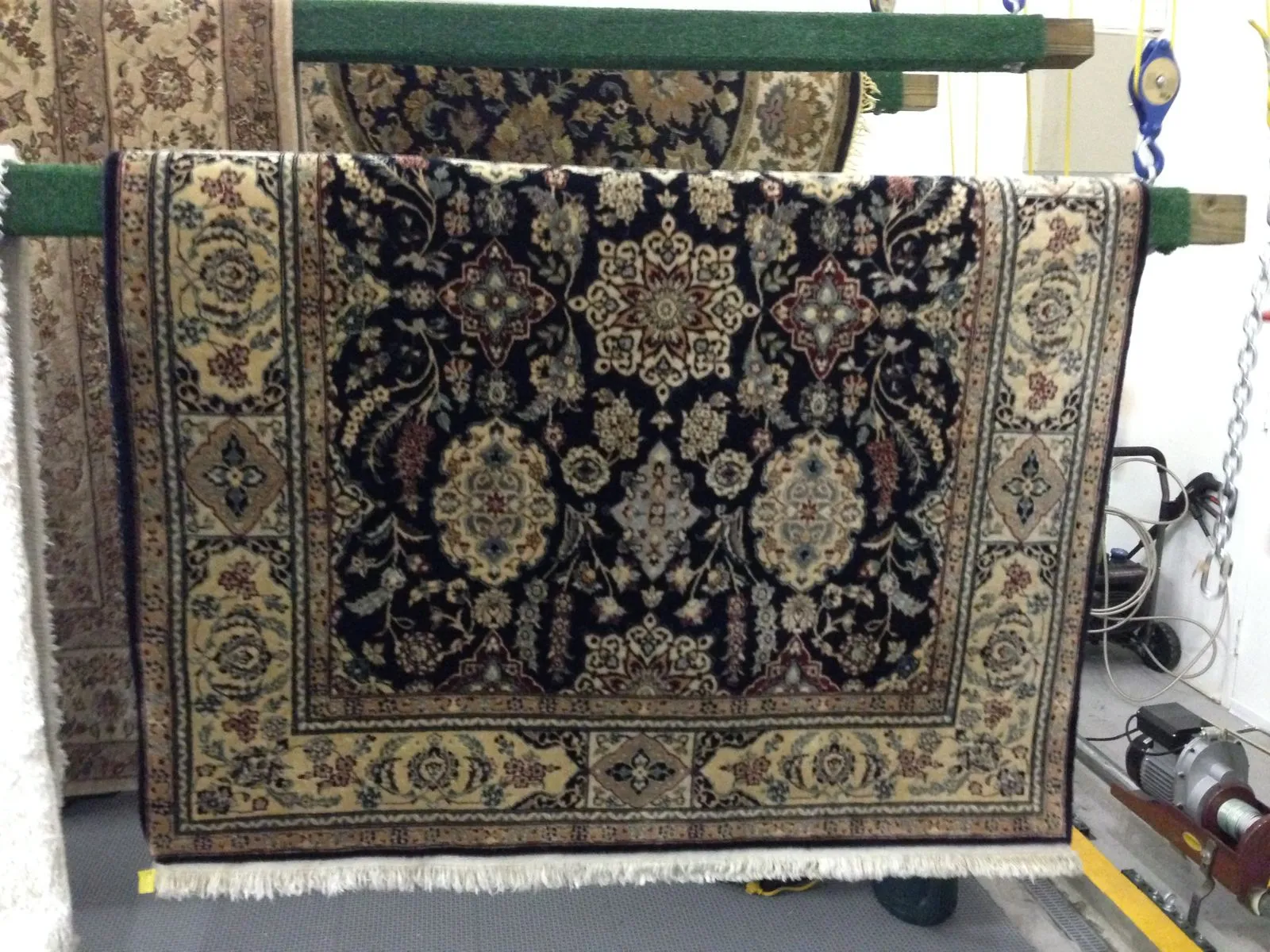 Oriental rug hung on a rack to air dry
